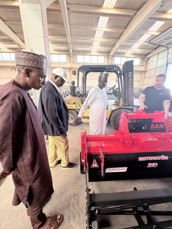 Examining agricultural implements on the factory floor