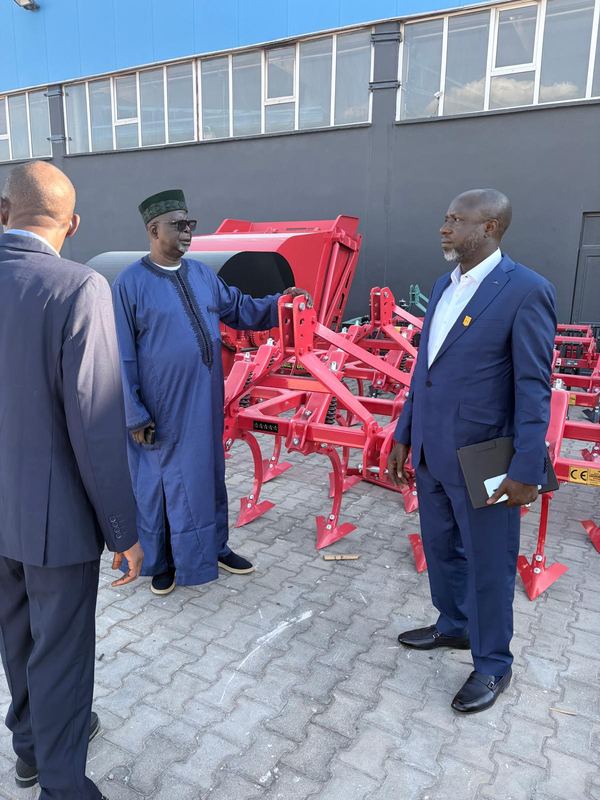 Evaluation meeting beside agricultural implements