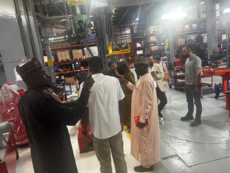 The Honourable Commissioner for Agriculture examining the production line