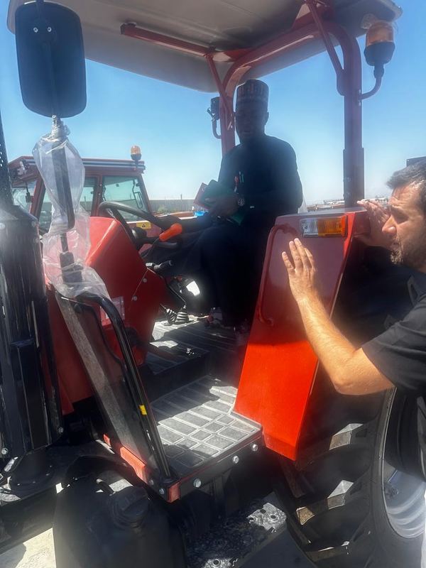 The Honourable Commissioner in the cab of a new tractor