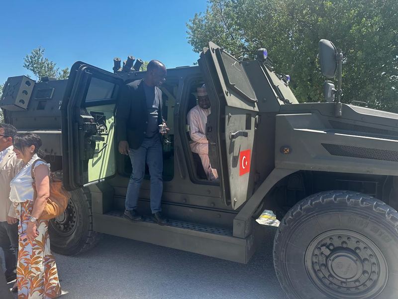 Delegates examining an armoured vehicle